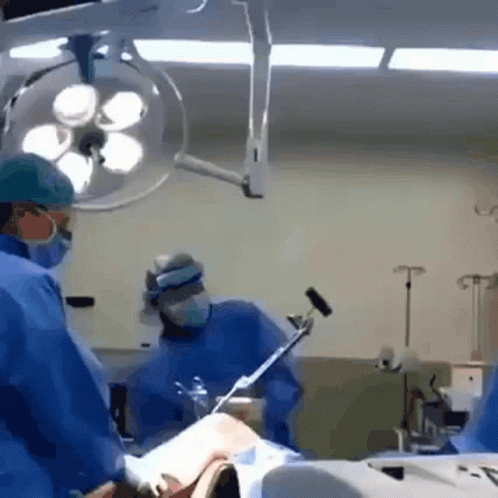 surgeons perform  in an emergency room in a hospital