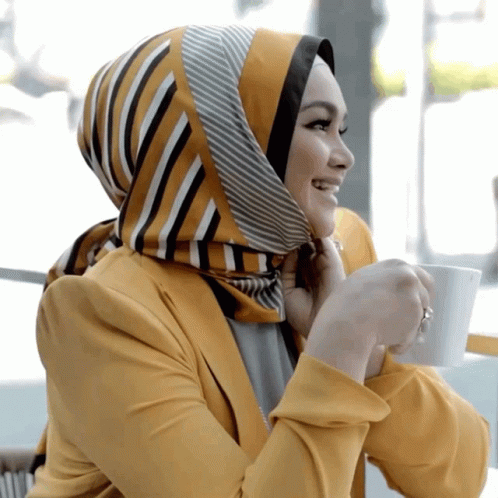 a woman with a striped scarf on talking on a phone