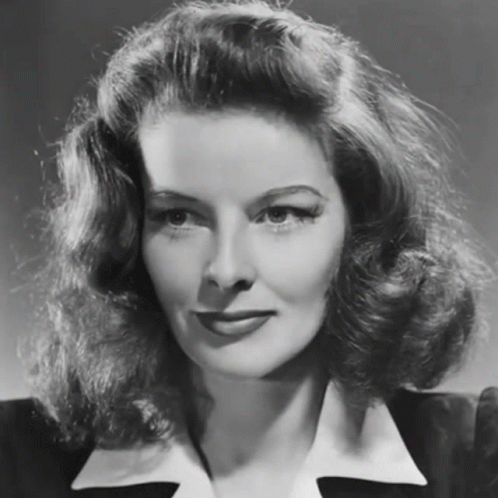 a vintage woman posing for a picture with her hair styled in a half up style