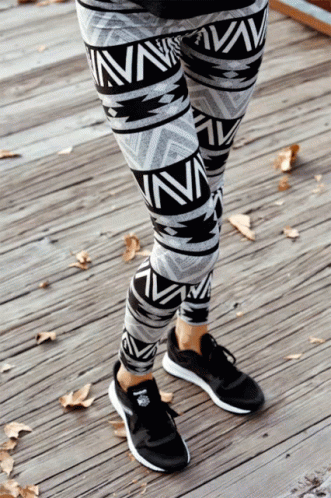 a person is wearing patterned pants and sneakers