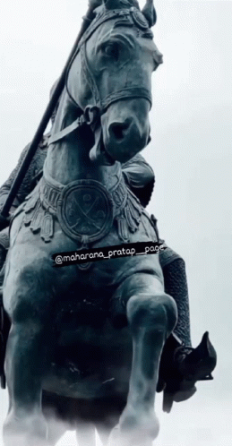 a statue of an indian man riding on a horse