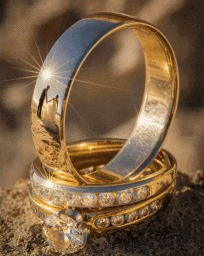 a couple of rings sitting on top of a stone