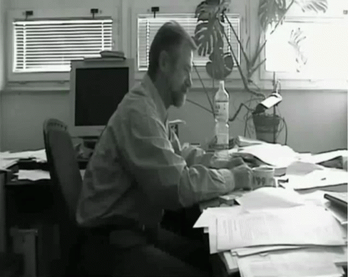 a man sitting at a desk in an office setting