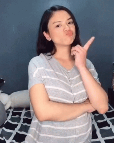a woman making the v sign in front of her face