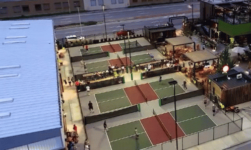 there is a tennis court set up near a tall building