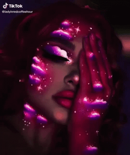 girl with purple makeup looks at the stars in her eyes