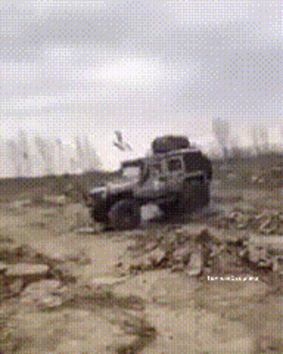 the jeep is driving down the muddy road