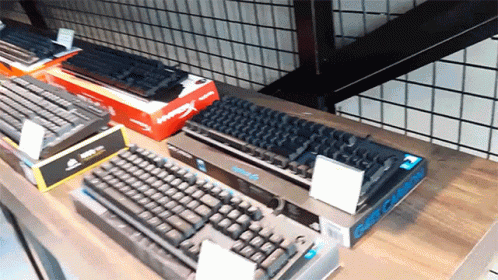 a row of keyboards sitting on top of a counter
