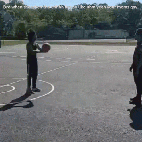 two children playing basketball on a basketball court