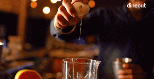an image of man pouring liquid into a measuring glass