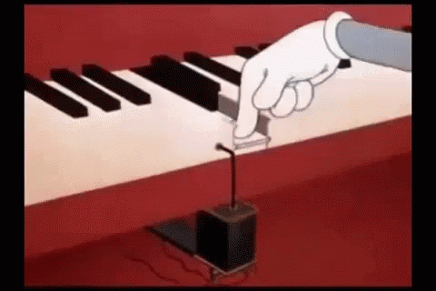 a hand presses a small musical  onto an electric keyboard