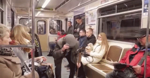 there are many people riding a subway train