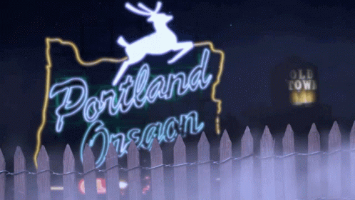 the sign for portland design lit up at night