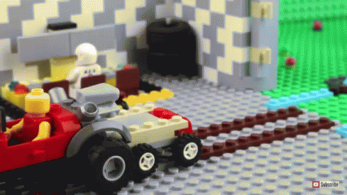 a toy of a car inside a building made out of legos