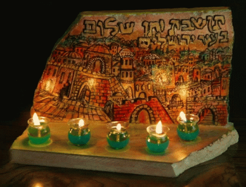 a blue tile with candles in front of it