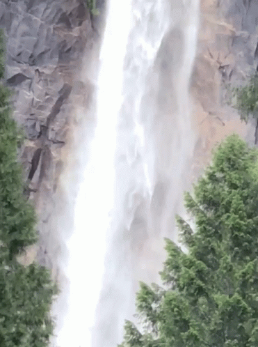 a waterfall shooting water while seen from a helicopter