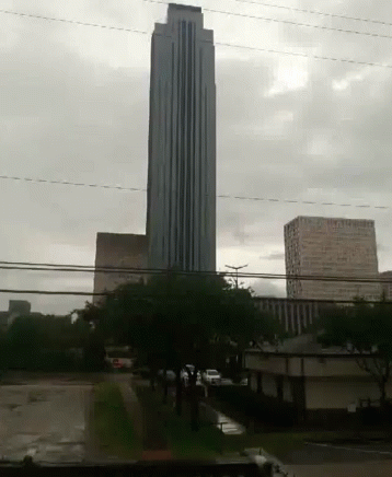a very tall building surrounded by other buildings