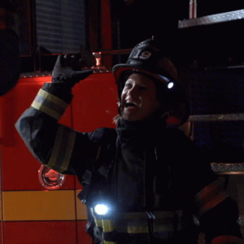 a fireman holding a wrench and light in his hand