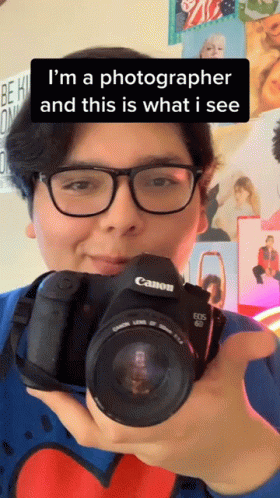 a man holding a camera with the captioning quote i'm a pographer and this is what i see