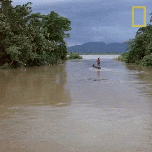 a man rowing a canoe through the water
