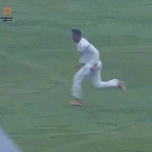 a man runs across a field in white