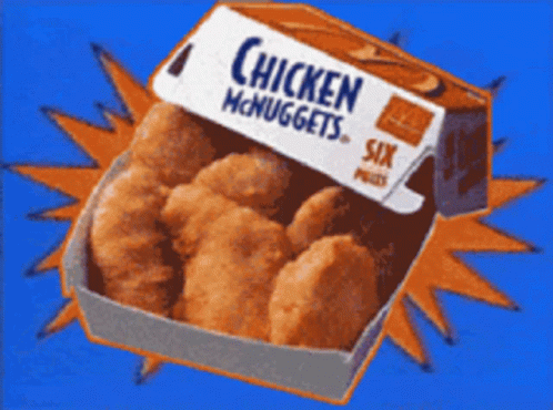 a box of chicken nuggets sitting on top of an orange background