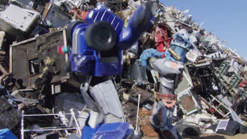 large collection of electronic devices and a robot on pile of rubble