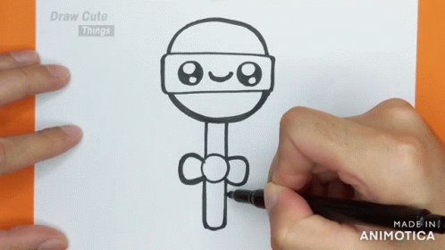 two hands holding a drawing of a cartoon character