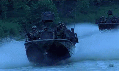 two soldiers going into water on a boat