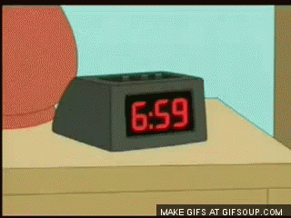 a clock is on a table and the time is 6 59