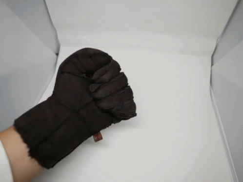 a black glove and a blue top
