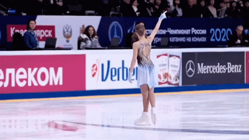 an ice skater wearing a blue costume skates