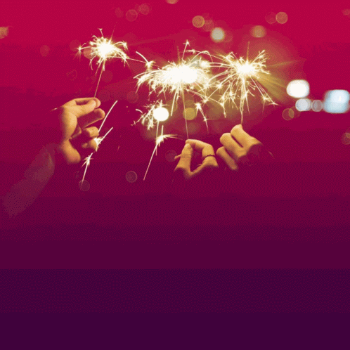 the hand is holding a small blue fireworks