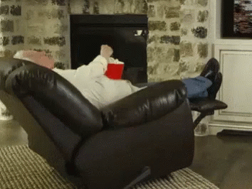 a man who is laying down on a recliner