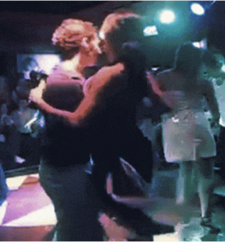 the man and woman are dancing together on the dance floor
