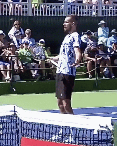 a tennis player holding his racquet with the ball coming in
