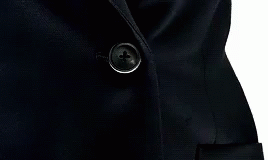 a close up of the collar and ons on a black suit jacket