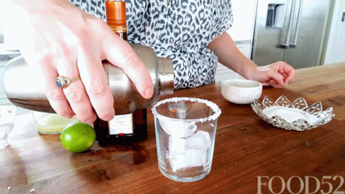 a woman is pouring salt into a glass
