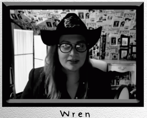 a woman with a hat and glasses in her room