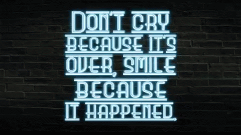 a neon sign that says don't cry because it's over smile because it happened