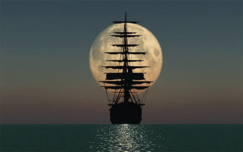 a full moon rising behind an old sail boat in the ocean
