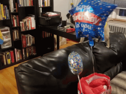 there are balloons flying over a couch