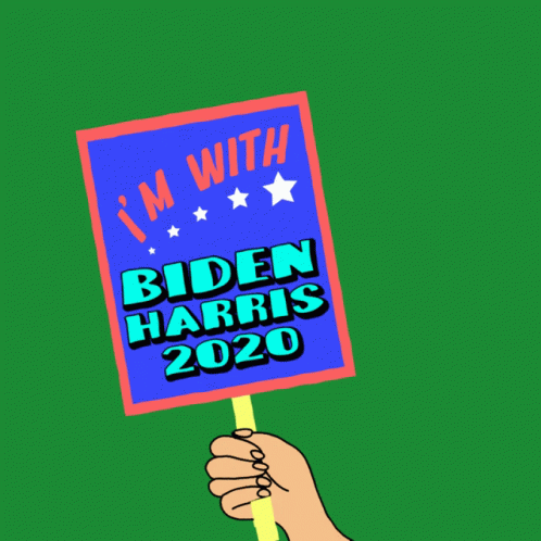 a hand holding a sign saying biden harris in a green background