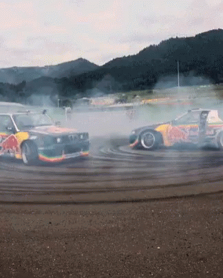 cars with smoke coming from them on a race track