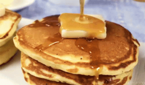 pancakes are made with blue icing and a lit candle