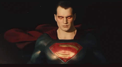 a close up view of a superman character in a dark room
