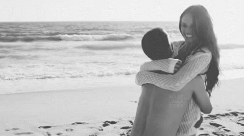 a couple in love hug on the beach
