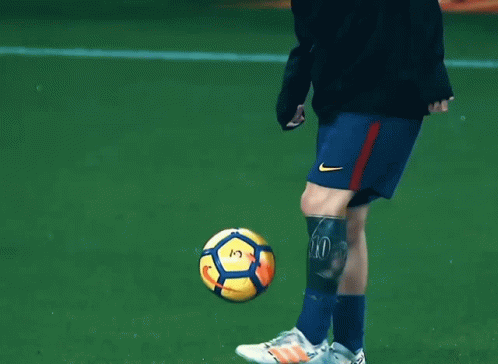 the ball is near a player's leg on the field