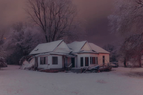 an old house in the middle of winter with snow
