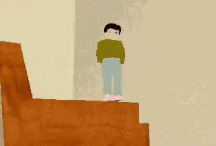 a boy is standing at the top of the stairs